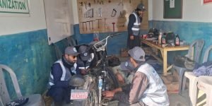 "Bike mechanic course students performing hands-on motorcycle repair at Jamil Khan Welfare Organization's vocational center in Beri Bari Topi, Bagh, AJ&K."